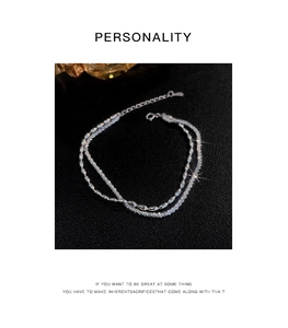 Detail of 925 silver plated double-layer bracelet with stars texture on black leather