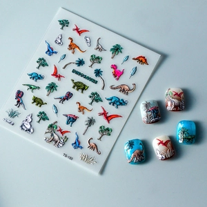 Macro detail of 5D embossed dinosaur nail art stickers with textured prehistoric motifs