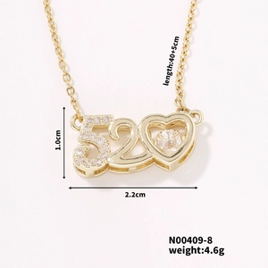 Detailed view of gold heart necklace pendant with 520 engraving and zircon inlay