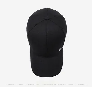 Top view of black cotton baseball cap showing 6-panel structure and metal side logo