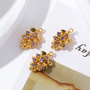 Detailed view of three 18K gold-plated grape pendants with purple cubic zirconia crystals