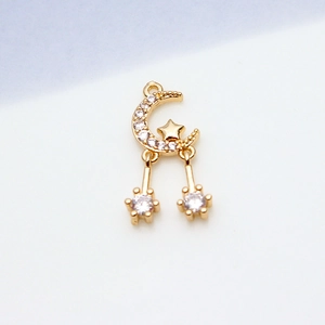 Close-up of gold-plated star and moon pendant with shimmering cubic zirconia stones