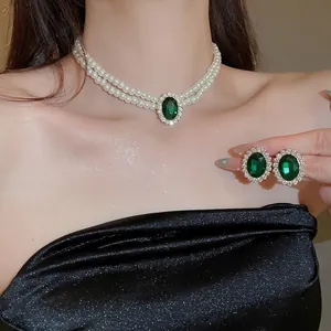 Elegant emerald pendant necklace and earrings set with double layer pearls on model