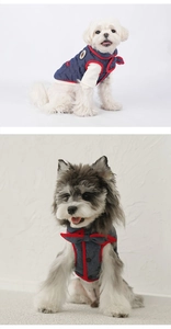 Detail of denim pet vest featuring red piping, bow decoration, and button closure