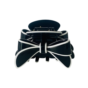 Detailed view of the black and white bow hair claw clip with multi-tooth design