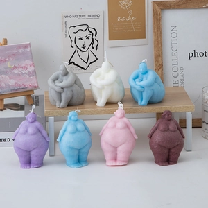 Artistic female body torso candles in various colors for creative home decor aesthetic