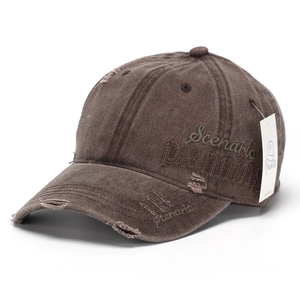 Detail view of vintage brown baseball cap with Scenario Planning embroidery and distressed fabric