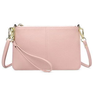 Detail of pink lychee textured leather and golden metal hardware on the shoulder bag