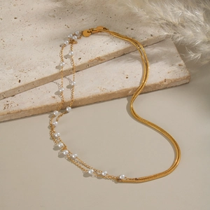 Elegant double-layered stainless steel necklace featuring a gold snake chain and pearl strand