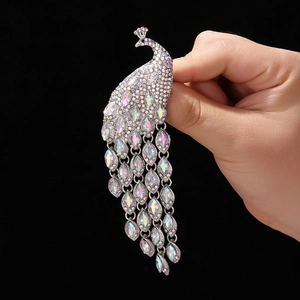 Sparkling crystal peacock brooch with long tassel fringes in silver-tone alloy finish