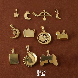 Macro view of the smooth back surface of various gold stainless steel charms