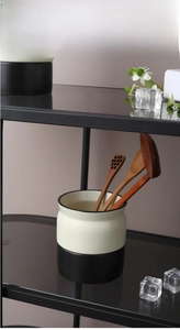 Close-up of Nordic dual-tone ceramic cutlery holder with wooden spoons in a kitchen setting