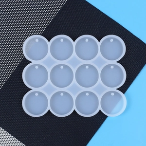 Top view of a 12-slot round silicone mold for DIY resin jewelry and keychain pendants