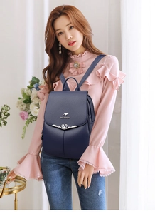 Deep blue faux leather backpack for women with metal logo and heart-shaped charm detail