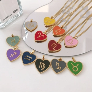 Macro shot of 12 colorful heart pendants with golden zodiac signs and matching chains