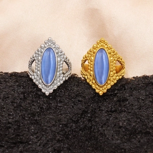 Detail of bohemian gold and silver beaded rings featuring oval blue natural stones