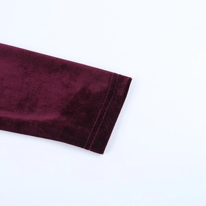 Close-up of wine red velvet fabric showing high-quality texture and double stitching