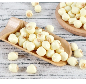 Macro detail of realistic PVC lotus seeds in a bamboo spoon on a wooden background