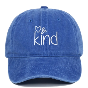 Detail of Be Kind embroidery with heart pattern on blue washed cotton baseball cap