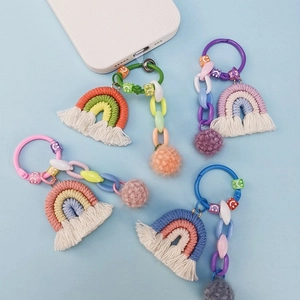 Detail of handmade rainbow macrame keychains with macaron tassels and smiley face beads