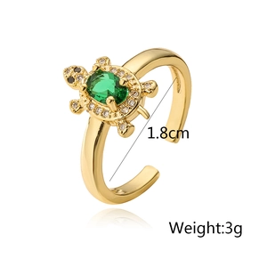 Detail view of turtle open ring in 18K gold plating with green stone and 1.8cm diameter