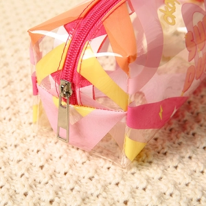 Transparent PVC makeup bag with pink zipper and colorful patterns for travel storage