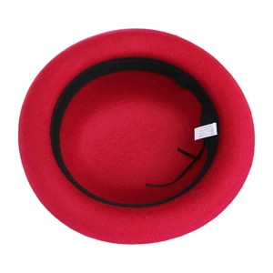 Detailed view of the red wool felt hat inner side, showing soft fabric and fine lining.