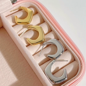 Polished geometric stainless steel stud earrings in gold and silver set in a pink box