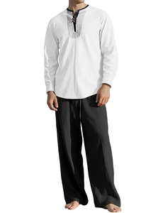 Detail of white long sleeve henley shirt with stripes and black linen-style drawstring pants