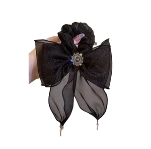Elegant black tulle bow hair scrunchie with decorative buckle and metal charms