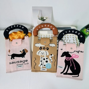 Three cute knitted crossbody phone bags in pink and khaki with cartoon dog patterns