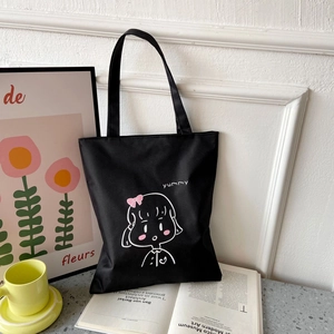 Minimalist black Oxford cloth tote bag with cute cartoon girl illustration and yummy text