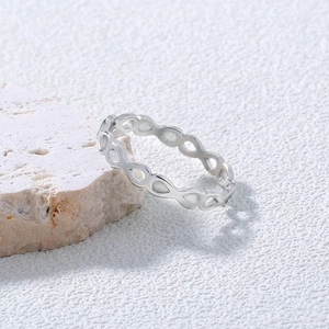 Close-up of hollowed water drop pattern on 304 stainless steel ring resting on natural stone