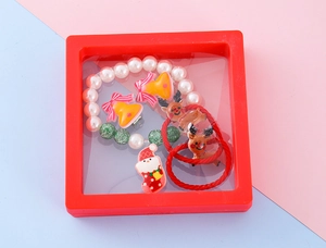 Detailed set of Christmas kids jewelry with reindeer hair ties and pearl bracelet