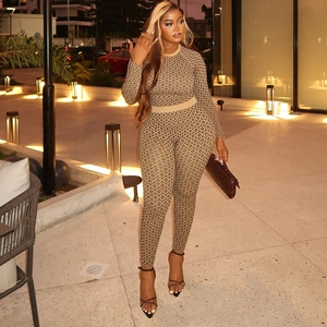 Close-up of slim-fit brown jumpsuit with geometric diamond patterns in warm outdoor lighting