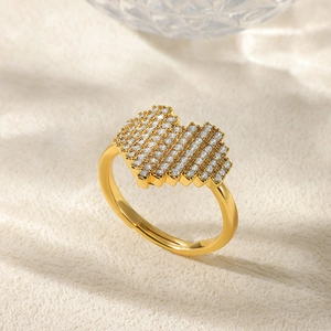 Detail of heart shaped golden ring with micro-paved cubic zirconia and open band