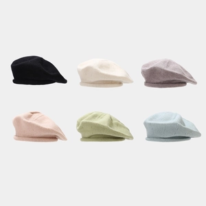 Detailed grid view of knitted beret hats in six colors including black and soft pastels