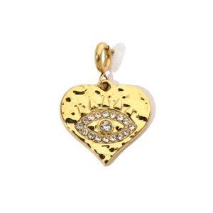 Macro detail of gold heart evil eye pendant with sparkling white rhinestones