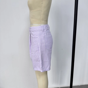 Detailed side view of high-waisted denim shorts featuring purple and white vertical stripes