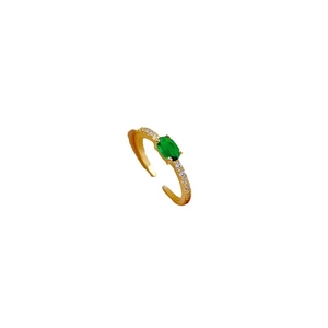 Adjustable gold plated ring featuring green zircon center stone and white side accents