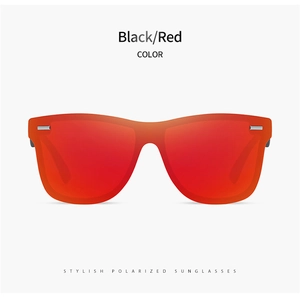 Detail view of stylish polarized sunglasses with black frame and vibrant red lenses