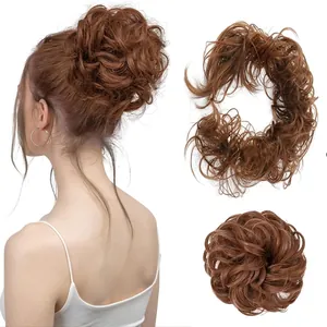 Detailed view of auburn messy bun hairpiece showing natural curly texture and elastic band