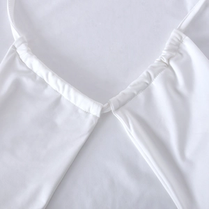 Close-up of white twill fabric texture and meticulous V-neckline stitching on the dress