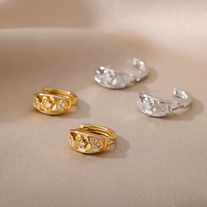 Elegant gold and silver flower hoop earrings with zircon stones on soft silk fabric