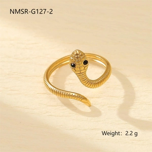 Macro detail of golden snake ring with black gemstone eyes and scaled texture weighing 2.2g