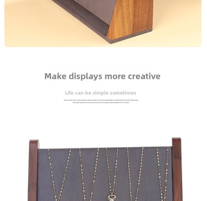 Macro view of walnut wood necklace display stand with dark grey matte texture backboard