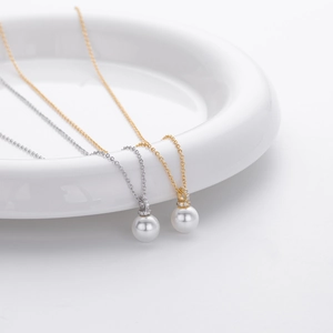 Detailed view of white pearl pendants on fine gold and silver 925 sterling silver chains