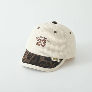 Close-up of corduroy texture, leopard print brim, and number 23 embroidery on kids cap