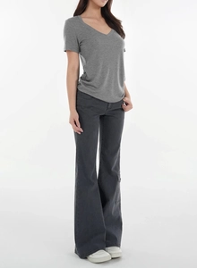 Close-up of a grey V-neck wool blend T-shirt paired with dark grey flared denim jeans