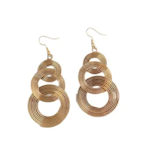 Chic gold metallic hollow winding tassel earrings with overlapping circular drop design
